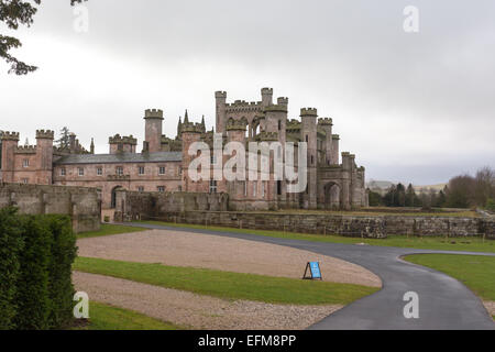 The side and front elevations of ruined Lowther Castle, near Penrith in Cumbria. The road leads into the stable yard. Stock Photo