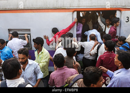 Commuters boarding train during evening rush hour at Bandra Railway Station in Mumbai, India. Stock Photo