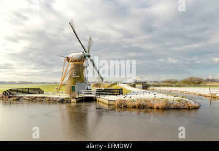 Drainage mill ''Hope springs eternal'' in typically Dutch flat landscape in winter, Voorhout, South Holland, The Netherlands. Stock Photo