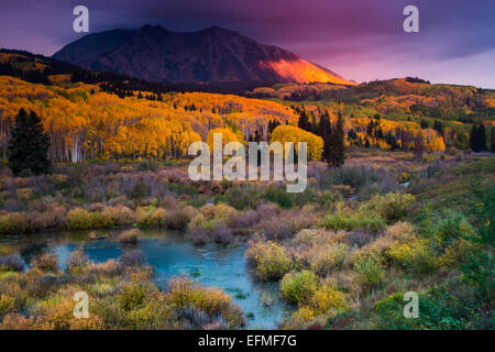 East Beckwith Mountain along Kebler pass in Colorado comes alive as the alpenglow paints the side of the mountain at sunrise Stock Photo