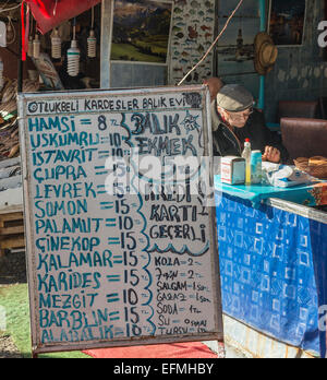 Menu outside a small fish taverna at the Fish market on Karakoy waterfront, Beyoglu,  Istanbul, Turkey. Stock Photo