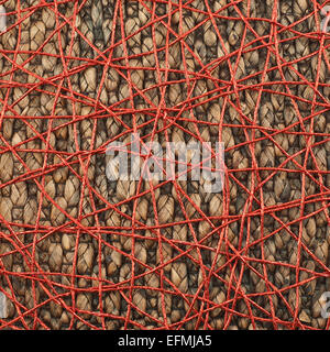 Wicker mat covered with red thread Stock Photo