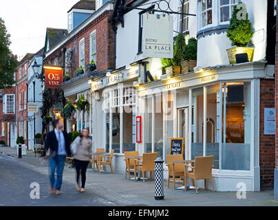 Couple walking past La Place Bistro and the Old Vine pub in Winchester, Hampshire, England UK Stock Photo