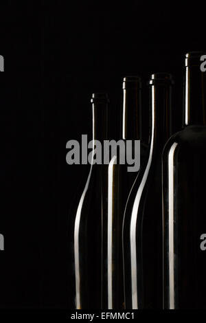 Silhouettes of elegant wine bottles on a black background Stock Photo