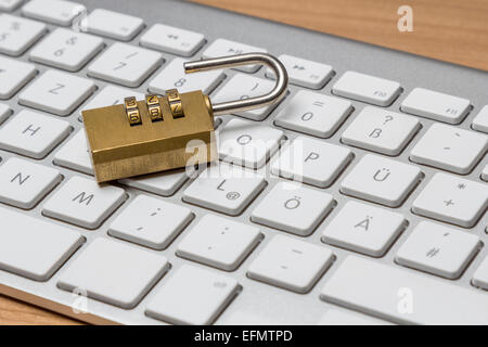 Modern silver keyboard with bress combination lock Stock Photo