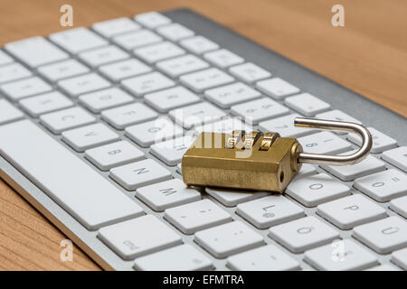 Modern silver keyboard with bress combination lock Stock Photo