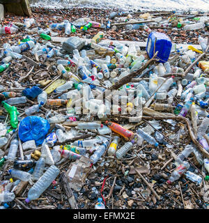 Rubbish Plastic Bottles Dumped in River Thames and Washed up on  a Beach Stock Photo