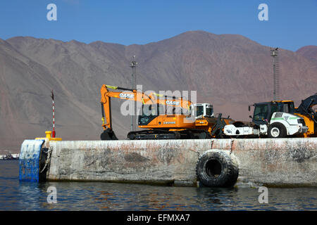 Newly imported excavators and tractors on quay in port, Iquique, Tarapaca  Region, Chile Stock Photo