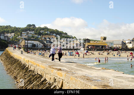 Tourists walking on the Banjo Pier, Looe, Cornwall, England, UK Stock Photo