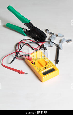 multimeter tester, press pliers and RJ45 connectors Stock Photo