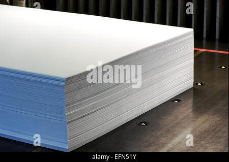 Close up Ream of Large Empty White Papers on a Wooden Platform Inside the Office. Stock Photo