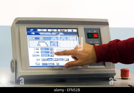 Close up Man Operating Touch Screen Device at the Table Inside the Office. Stock Photo