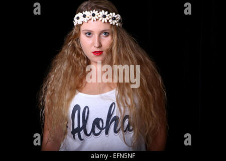 Young female teen with long blond hair and a wreath of flowers on her head. Model released Stock Photo