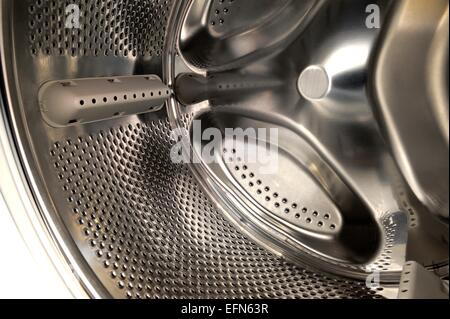 A chrome automatic washing machine drum close up. Stock Photo