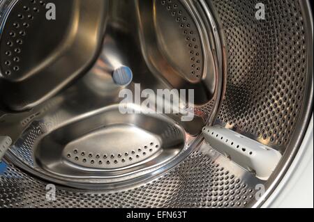 A chrome automatic washing machine drum close up. Stock Photo