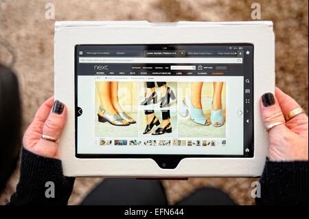 A kindle fire being used to view the Next online shopping site England UK Stock Photo