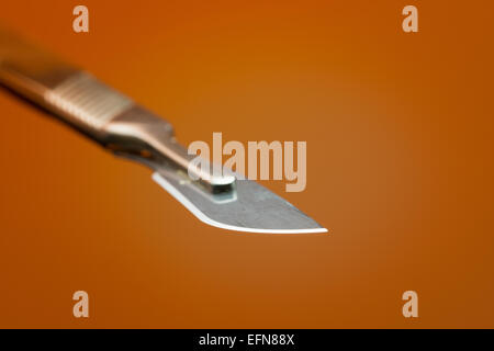 razor sharp surgical stainless steel blade on scalpel used for clinical operations in clean sterile environment Stock Photo