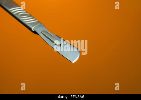 razor sharp surgical stainless steel blade on scalpel used for clinical operations in clean sterile environment Stock Photo