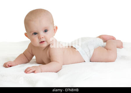 Cute baby lying on white towel in nappy or diaper Stock Photo
