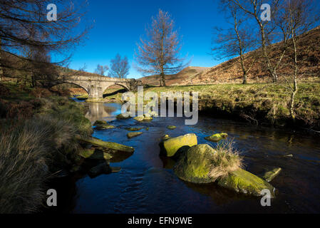 Packhorse bridge at Slippery stones over the river Derwent in the Peak District on a sunny autumn day. Stock Photo