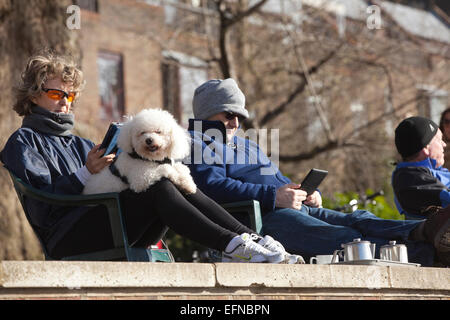 London, UK. 08th Feb, 2015. The London Borough of Richmond upon Thames in south-west London, England, UK 08.02.2015 People sit along the Thames River pathway enjoying the sunny winter weather as temperatures reach 10 degrees in Richmond, Outer London, UK Credit:  Jeff Gilbert/Alamy Live News Stock Photo