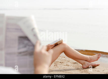 Woman feet in sand on the beach Stock Photo