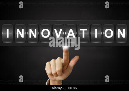 business hand pushing innovation on Flipboard Display Stock Photo