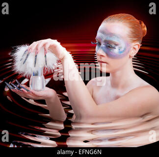 Photo of a girl with long fingernails and trendy makeup, she holds in the hands a jar of cream Stock Photo