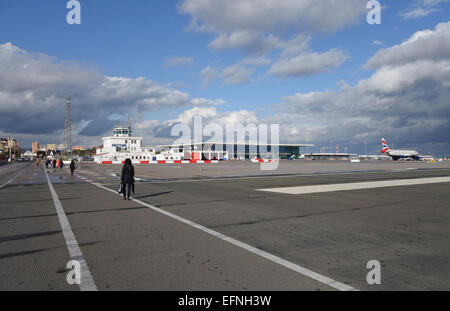 Gibraltar rock. Cars and pedestrians cross the runway of airport at the border of Spain and Gibraltar. overseas territory Gibraltar. Stock Photo