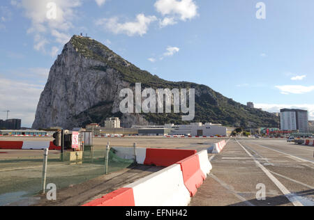 Gibraltar rock. Cars and pedestrians cross the runway of Gibraltar airport at the border of Spain to enter Gibraltar. Uk. United Kingdom. Stock Photo