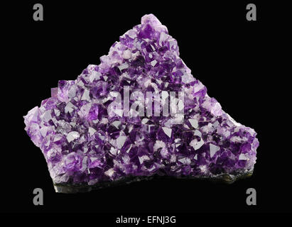 Amethyst on black background, a violet variety of quartz, often used in jewelry. Silica, silicon dioxide, SiO2. Stock Photo