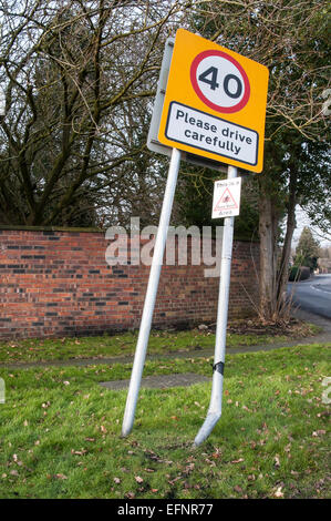 Road sign please drive carefully damaged by car Stock Photo