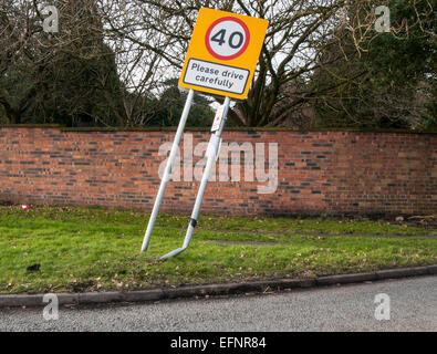 Road sign please drive carefully damaged by car Stock Photo