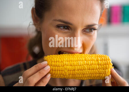 Young woman eating boiled corn Stock Photo