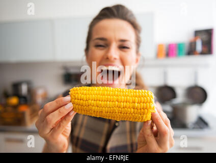 Closeup on young woman eating boiled corn Stock Photo