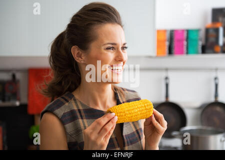 Portrait of happy young woman with boiled corn Stock Photo
