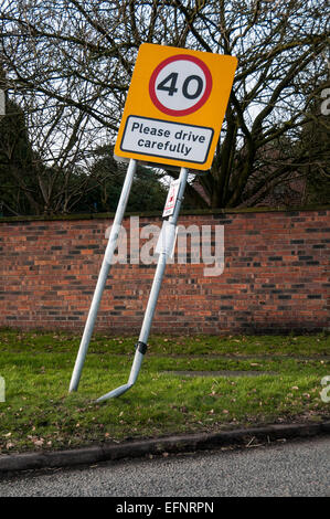 Road sign please drive carefully damaged by car Stock Photo