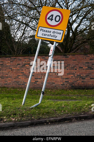 Road sign please drive carefully damaged by car Stock Photo