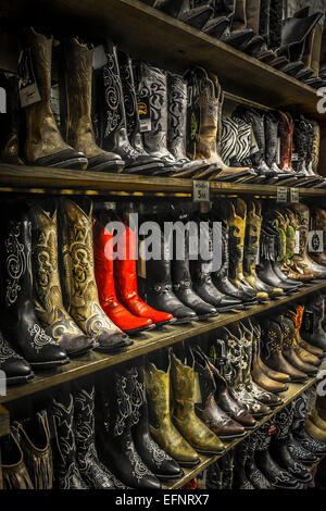 Multiple shelves of unique cowboy boots on display at downtown Broadway boot store in Nashville, TN, Music City USA Stock Photo