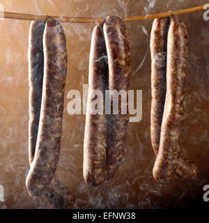 Smoked sausage in a haze of smoke Stock Photo