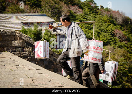 Workers load boxes of water bottles at the distribution center of ...
