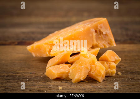 Italian Parmesan Cheese on Wooden Background close up Stock Photo