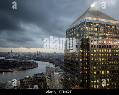 High finance on a gray day the City of London financial district, Canary Wharf in the docklands at dusk Stock Photo