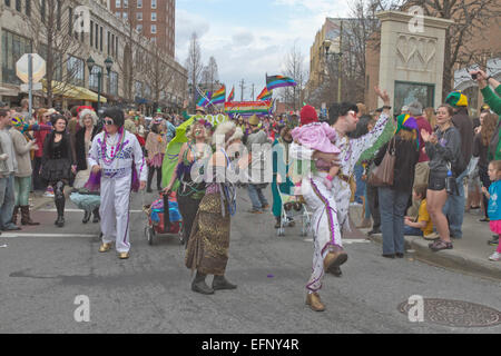 Two Elvis characters along with people in other creative costumes frolic in the Asheville, NC Mardi Gras Parade Stock Photo