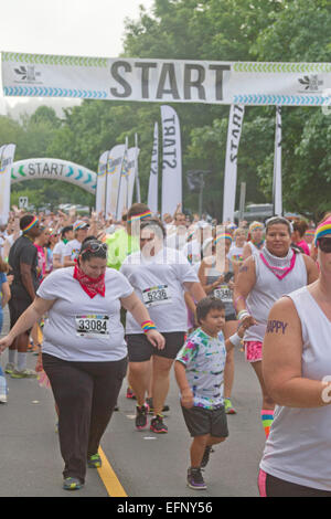 Happy Color Run crowd takes off from the starting line on July 26, 2014 in downtown Asheville, NC Stock Photo