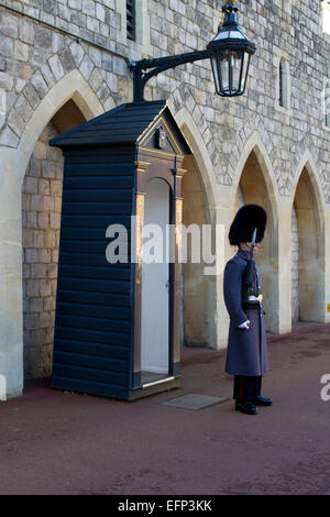 Queen's Guardsman on sentry duty at Windsor Castle, Berkshire, England in January Stock Photo