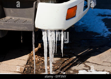 Icicles hanging from car bumper - USA Stock Photo