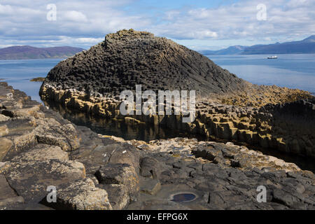 Basalt columns next to Fingal's Cave on the Isle of Staffa, with Mull in the background, Inner Hebrides, Scotland, UK Stock Photo