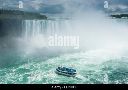 Tourist boat in the mist of the Horseshoe Falls (Canadian Falls), Niagara Falls, Ontario, Canada, North America Stock Photo