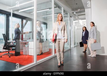 Woman standing outside interview room Stock Photo